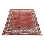 Large Persian Araak rug carpet, the red field decorated with repeating boteh motifs, multiple band b