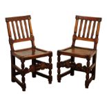 Pair of country made late 17th/18th century oak chairs, moulded slat backs and solid seats on turned