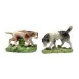 Two 19th century Staffordshire models of hunting dogs, each stood upon naturalistically modelled bas