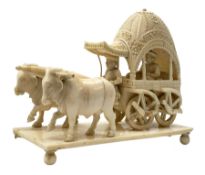 Early 20th century Indian carved ivory figure group, modelled as a foliate detailed carriage contain