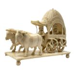 Early 20th century Indian carved ivory figure group, modelled as a foliate detailed carriage contain