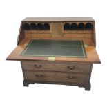 George lll mahogany bureau with crossbanded fall front, the interior with cupboard, drawers and com