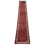 Persian Hamadan red ground runner rug, the field decorated with herati motifs, geometric design bord