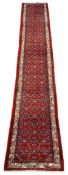 Persian Hamadan red ground runner rug, the field decorated with herati motifs, geometric design bord