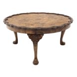 Early 20th century walnut coffee table, quarter veneered top with moulded pie crust edge carved with