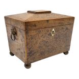 George III burr yew tea caddy, of sarcophagus form with lion mask ring handles and four brass ball f