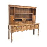 George III oak dresser, dentil cornice over open shelves and cupboards, three drawers under, raised