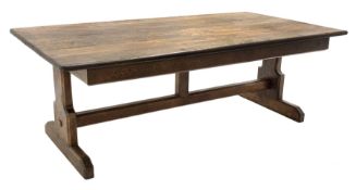 Large oak refectory dining table, rectangular moulded plank top, shaped end supports connected by st