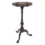 Small Georgian style mahogany tripod wine table, figured hexagonal top with pierced gallery, turned