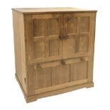 'Lizardman' panelled oak cabinet fitted double cupboard above two fall front compartments, with pres