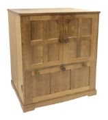 'Lizardman' panelled oak cabinet fitted double cupboard above two fall front compartments, with pres