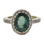 18ct gold oval green stone and diamond cluster ring, with diamond set shoulders by Lorique, hallmark