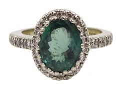 18ct gold oval green stone and diamond cluster ring, with diamond set shoulders by Lorique, hallmark