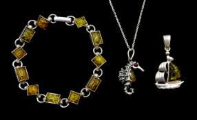 Silver amber seahorse pendant necklace, silver amber bracelet and a silver green amber boat pendant,