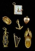 Seven 9ct gold charms including a soda siphon, baby in a basket, harp, Indian shoe and a book, hallm