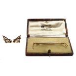 9ct gold riding crop brooch, retailed by Waddinton & Son boxed and a pair of 9ct gold clip on earrin