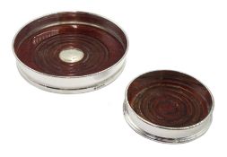 Silver wine coaster with turned wooden base by Barker Ellis Silver Co and one smaller one by P H Vog