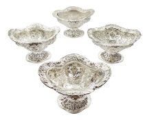 Four Victorian silver pedestal bon bon dishes, embossed foliate and pierced decoration, with glass l