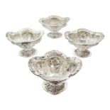 Four Victorian silver pedestal bon bon dishes, embossed foliate and pierced decoration, with glass l