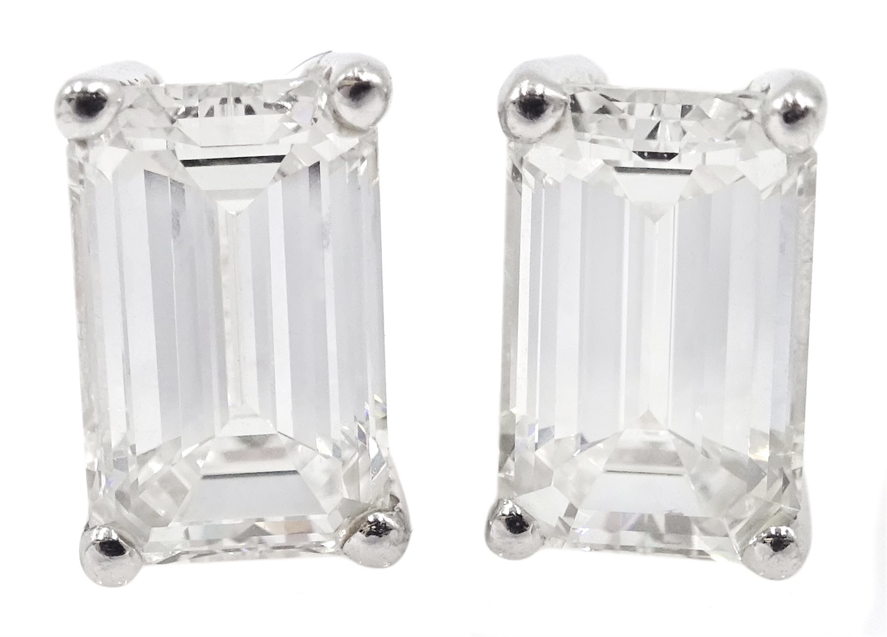 Pair of 18ct white gold emerald cut diamond stud earrings, hallmarked, total diamond weight 1.80 car