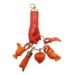 Victorian gold carved coral hand charm holding a heart, hand, jug, sword and mouse