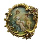 19th century painting on ivory depicting Cupid and maiden, in ornate gilt brooch set with split pear