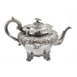 Victorian silver teapot, embossed floral and foliate decoration on four scroll feet by Martin, Hall