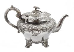 Victorian silver teapot, embossed floral and foliate decoration on four scroll feet by Martin, Hall