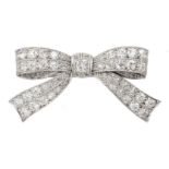 Art Deco white gold and platinum, milgrain set diamond bow brooch, stamped 18 & PT, the central cush