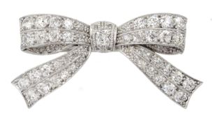 Art Deco white gold and platinum, milgrain set diamond bow brooch, stamped 18 & PT, the central cush