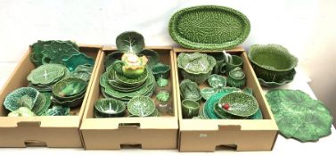 A large collection of various cabbage leaf wares, to include various bowls, dishes, plates, teapots,