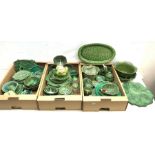 A large collection of various cabbage leaf wares, to include various bowls, dishes, plates, teapots,