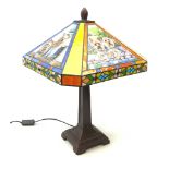 A Tiffany style table lamp, the leaded glass panel decorated with with panels of Yorkshire Terrier,