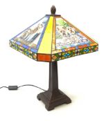 A Tiffany style table lamp, the leaded glass panel decorated with with panels of Yorkshire Terrier,