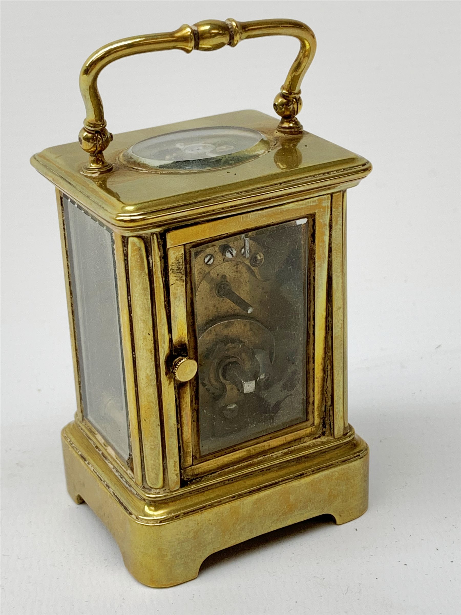 A brass cased miniature carriage clock, the white enamel dial with black Roman numerals, H7cm. - Image 4 of 7