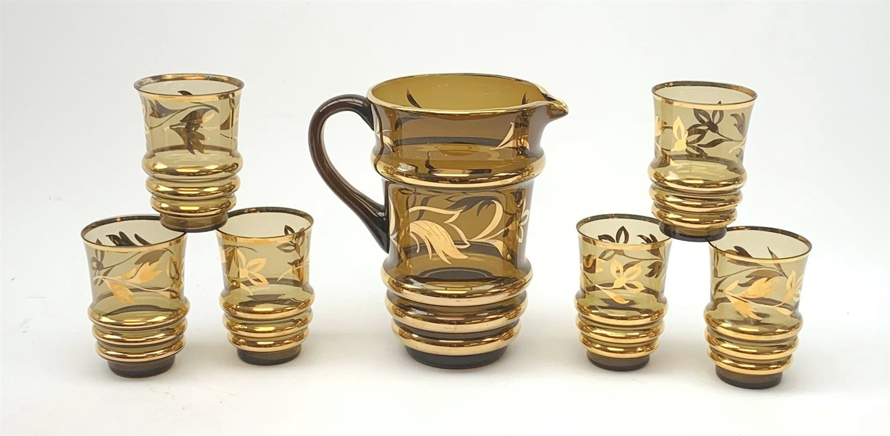 A 1950's smoked glass and gilt seven piece lemonade set.