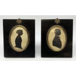 A pair of Victorian silhouettes, lady and gentleman, each facing dexter, within ebonised frames with