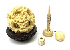 A Chinese carved ivory puzzle ball, with 9 concentric layers an carved with dragons (lacking base),