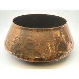 A large copper eastern vessel, of compressed ovoid form detailed with interwoven arabesque decoratio