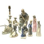 A group of figurines, to include a large Nao example, H32.5cm, and a Lladro table lamp, (a/f).