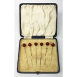 A cased set of six Art Deco Sterling silver cocktail sticks with cherry modelled terminals, marked S