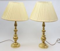 A pair of large gilt effect table lamps with knopped stems, with cream pleated shades, overall H84cm