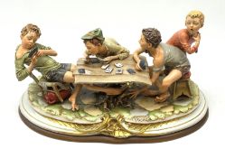 Large Capodimonte figure group 'The Card Cheat', modelled as four card players, signed Merli, raised