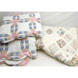 A Vintage style patchwork double quilt or bed spread, together with two single examples.