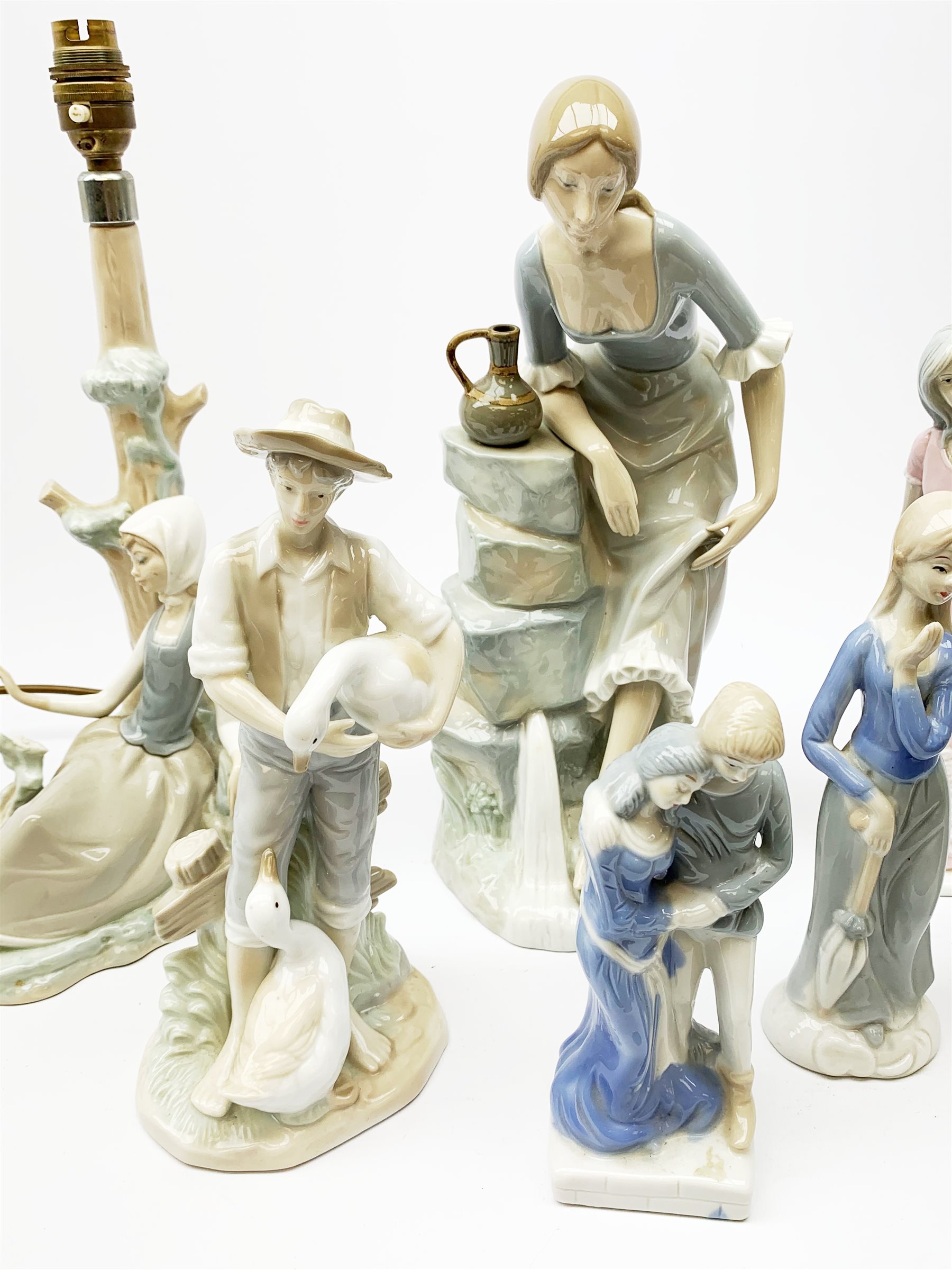 A group of figurines, to include a large Nao example, H32.5cm, and a Lladro table lamp, (a/f). - Image 3 of 4