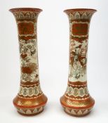 A pair of Japanese Kutani vases, of tapering form, decorated with figural panels, and panels contain