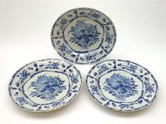 Three 19th century blue and white Delft plates, each with floral decoration, D30.5cm.