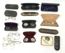 Twelve pairs of Georgian and later spectacles, one pair marked TA&B, with eleven cases, including a