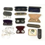 Twelve pairs of Georgian and later spectacles, one pair marked TA&B, with eleven cases, including a