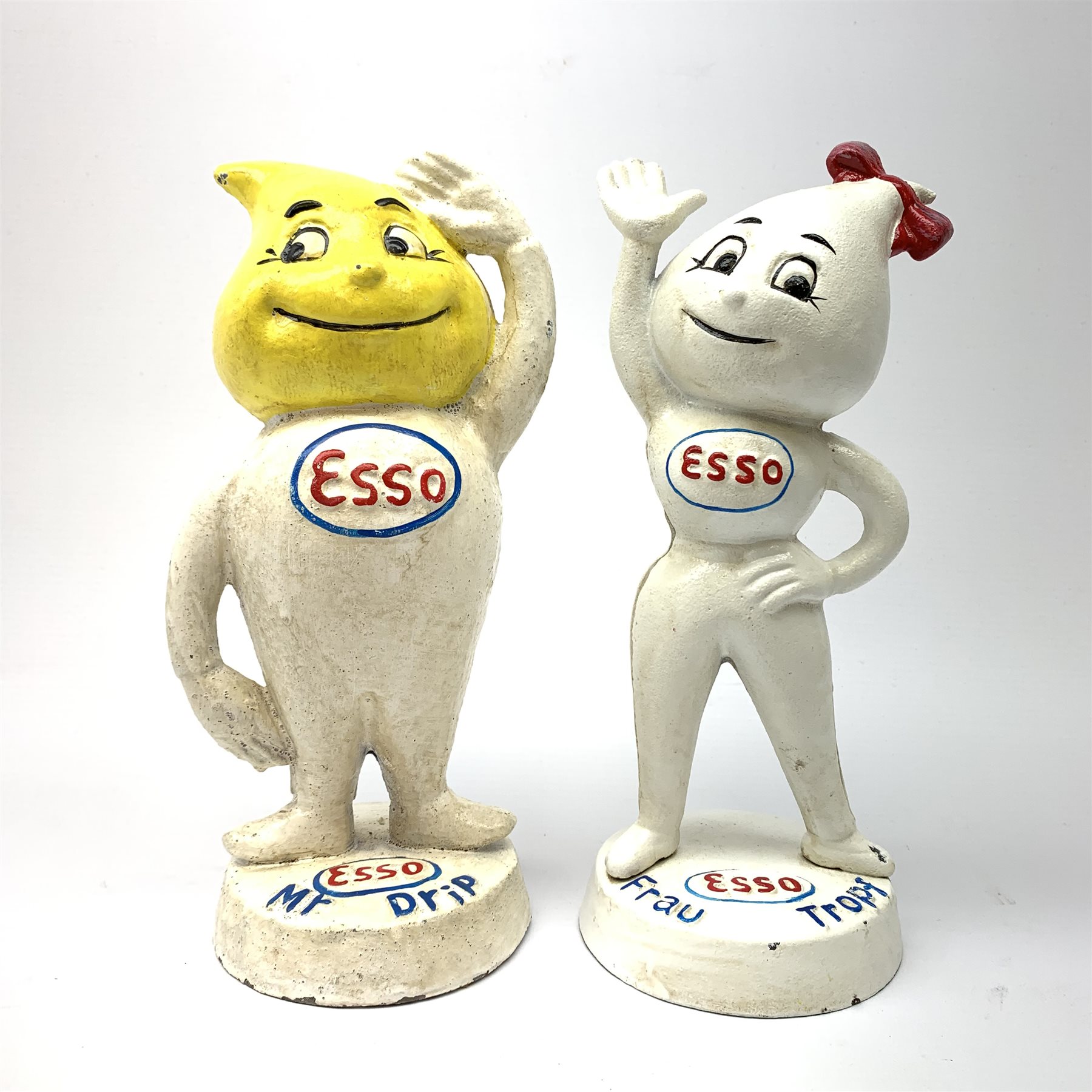 A pair of reproduction Esso money boxes, modelled as male and female mascots, each approx H23.5cm.